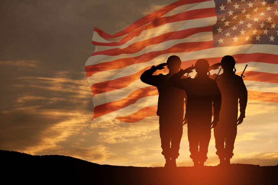 PSD - USA army soldiers saluting on a background of USA flag. Greeting card for Veterans Day, Memorial Day, Independence Day.